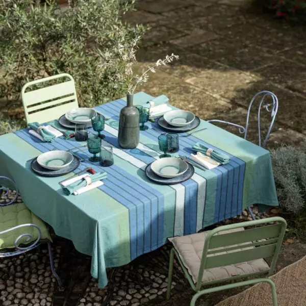 Outdoor table set for four with the YUNA Peacock striped tablecloth