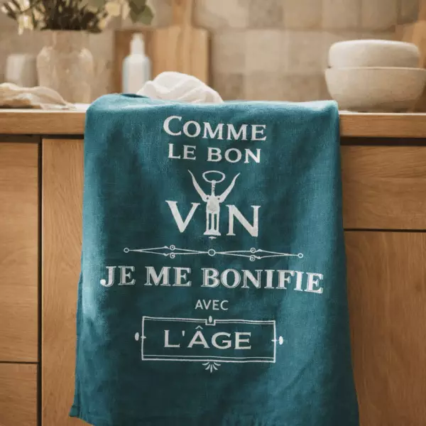 Paño de cocina con mensaje «Como el buen vino» - Pavo real, 70 x 50